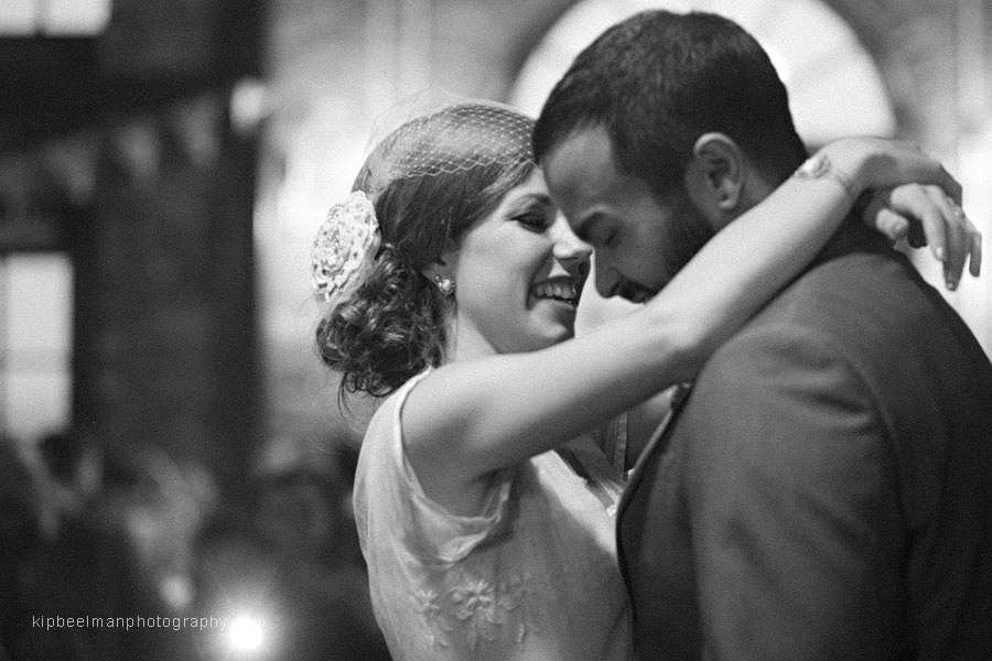 A couple dance their first dance at their Golden Gardens Bathhouse Wedding with an intimate, moody black and white photo