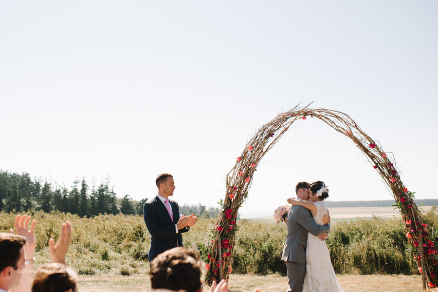 Bride and Groom under rose alter